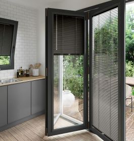 A dark grey perfect fit blind on a set of anthracite bifold doors
