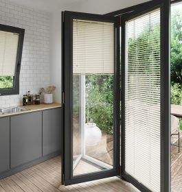 A soft cream coloured perfect fit blind on a set of anthracite bifold doors