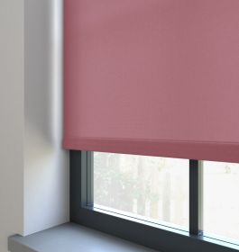 Our Burst Blushed Plum Roller blind in a living room window.