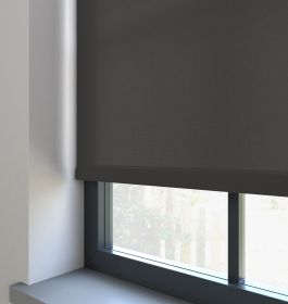 Our Burst Midnight dimout roller blind in a bedroom window.