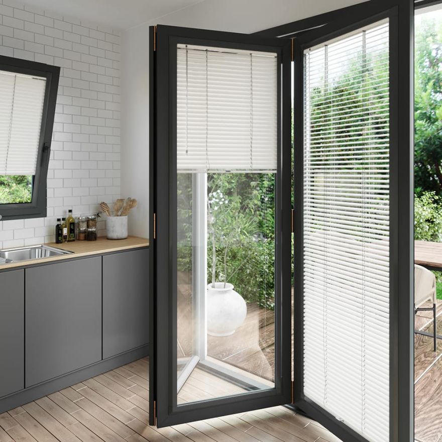 A soft grey perfect fit blind on a set of anthracite bifold doors