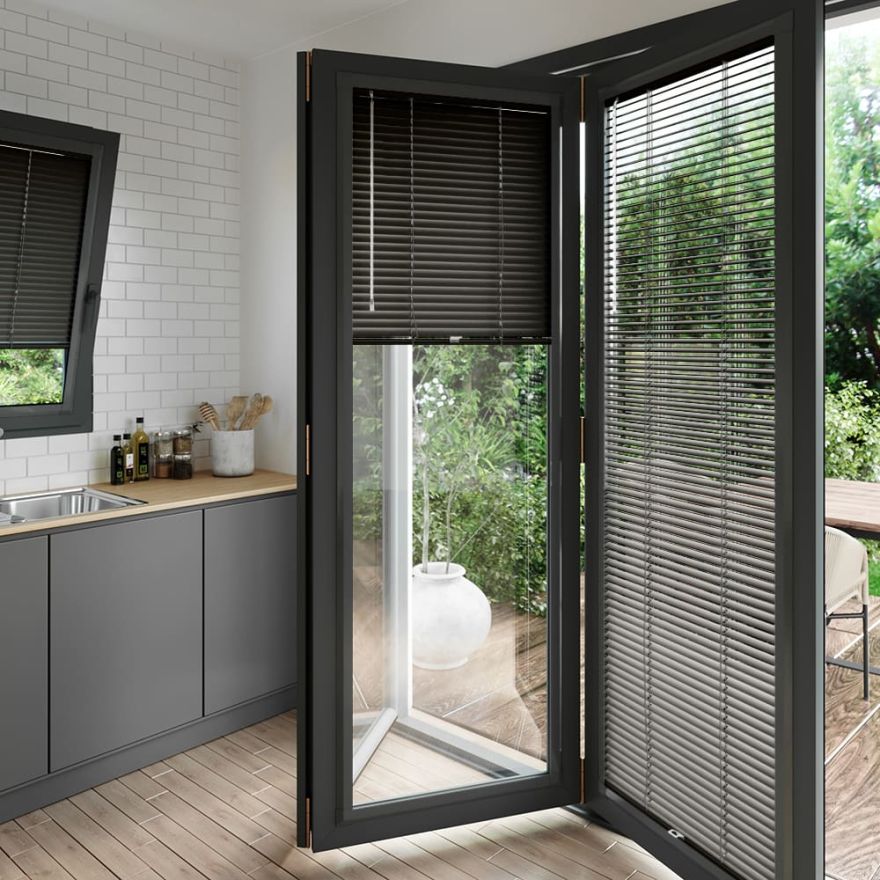 A dark grey perfect fit blind on a set of anthracite bifold doors
