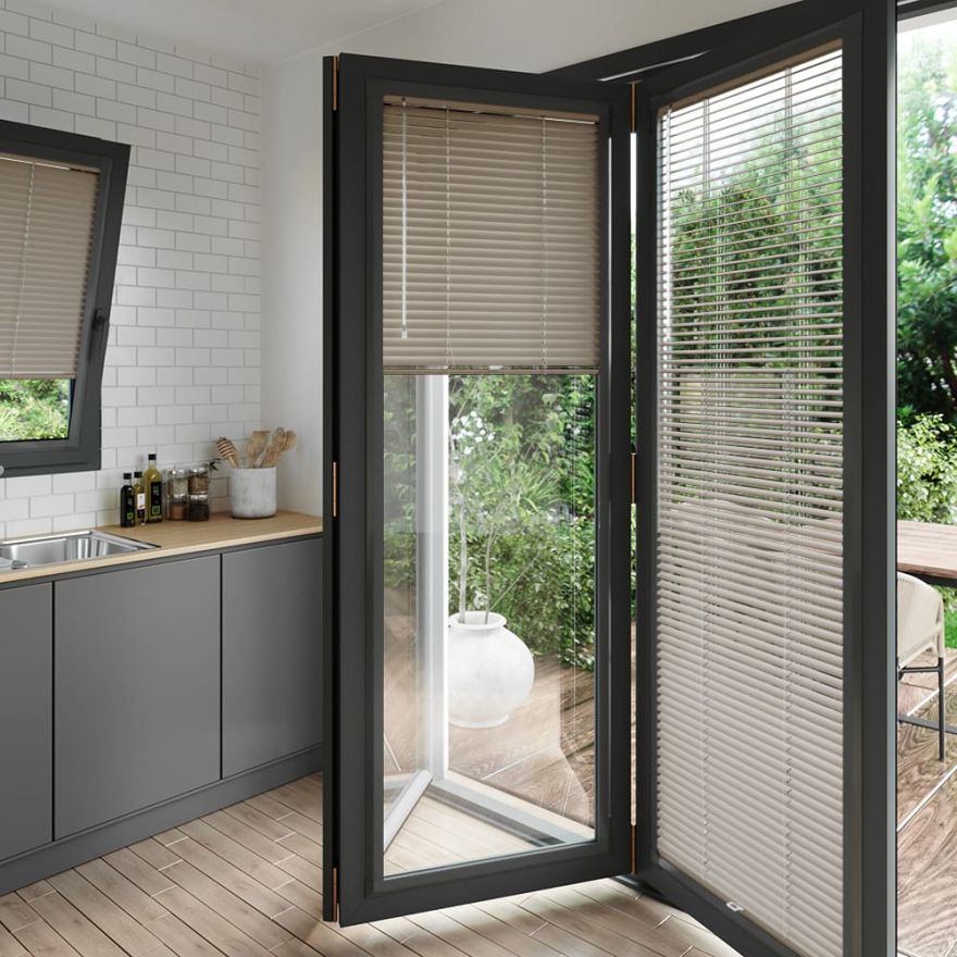 A light brown coloured perfect fit blind on a set of anthracite bifold doors
