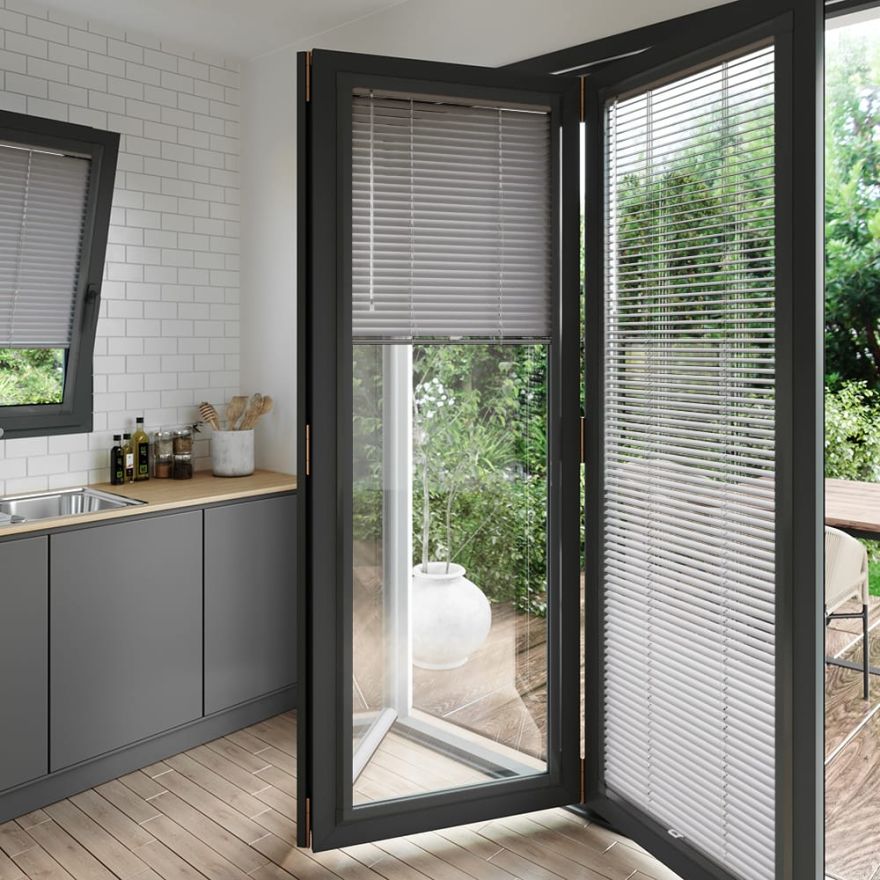 A grey coloured perfect fit blind on a set of anthracite bifold doors