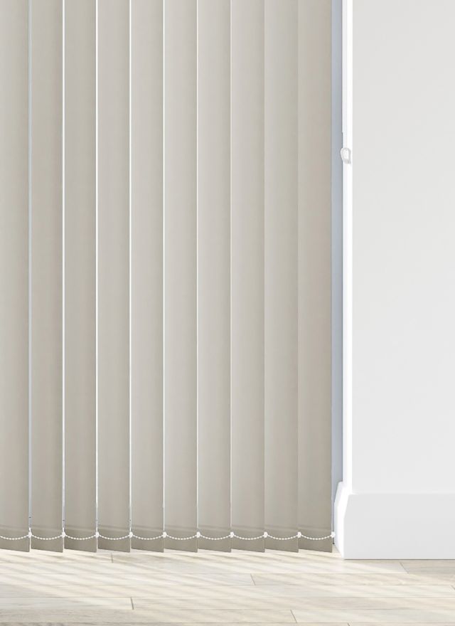 A cream vertical blind in a bathroom window 