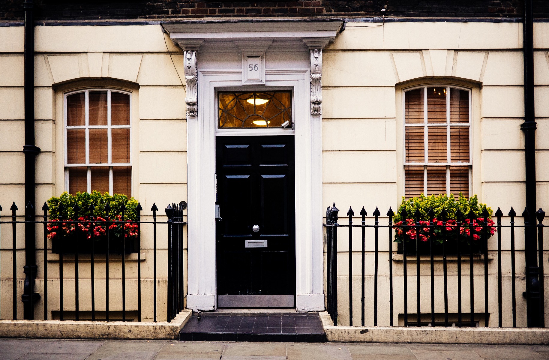 Front of the house with two wooden venetian blinds in the window